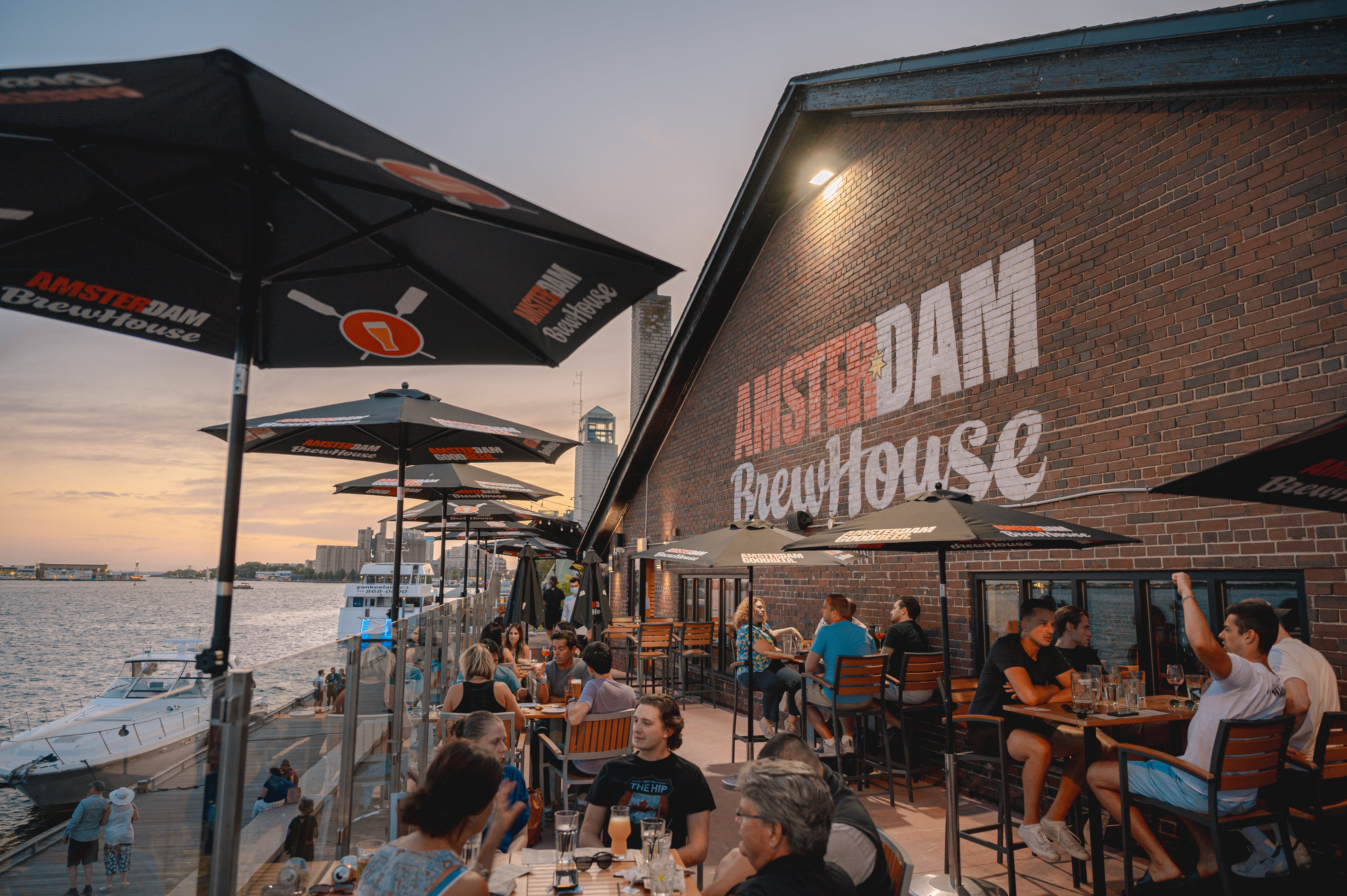 Lakeside view of Amsterdam Brewhouse showing people sitting outside